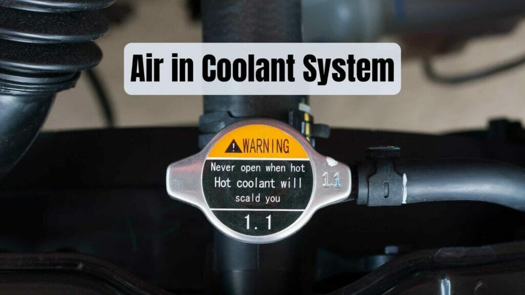 Photo closeup of a coolant system cap with a warning. Air in Coolant System.