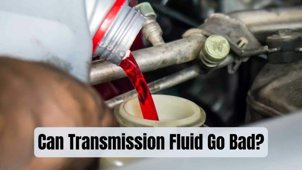 Photo of a person pouring transmission fluid in a car. Can Transmission Fluid Go Bad?