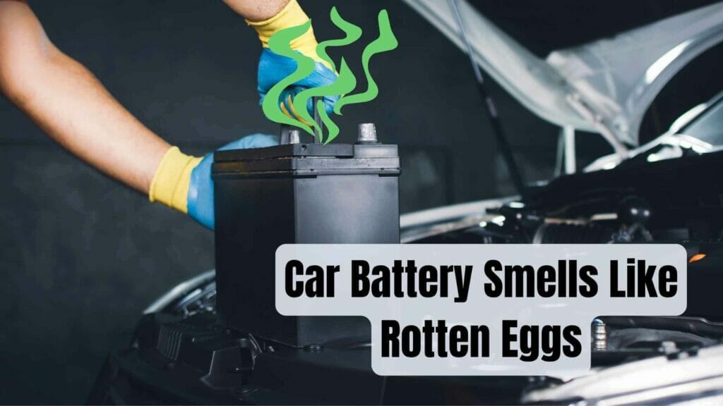 Photo of a person taking out a car battery emanating a bad rotten eggs smell. Car Battery Smells Like Rotten Eggs.