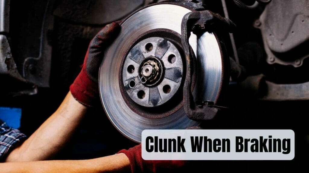 Photo of a person looking for issues on a brake disc. Clunk When Braking.